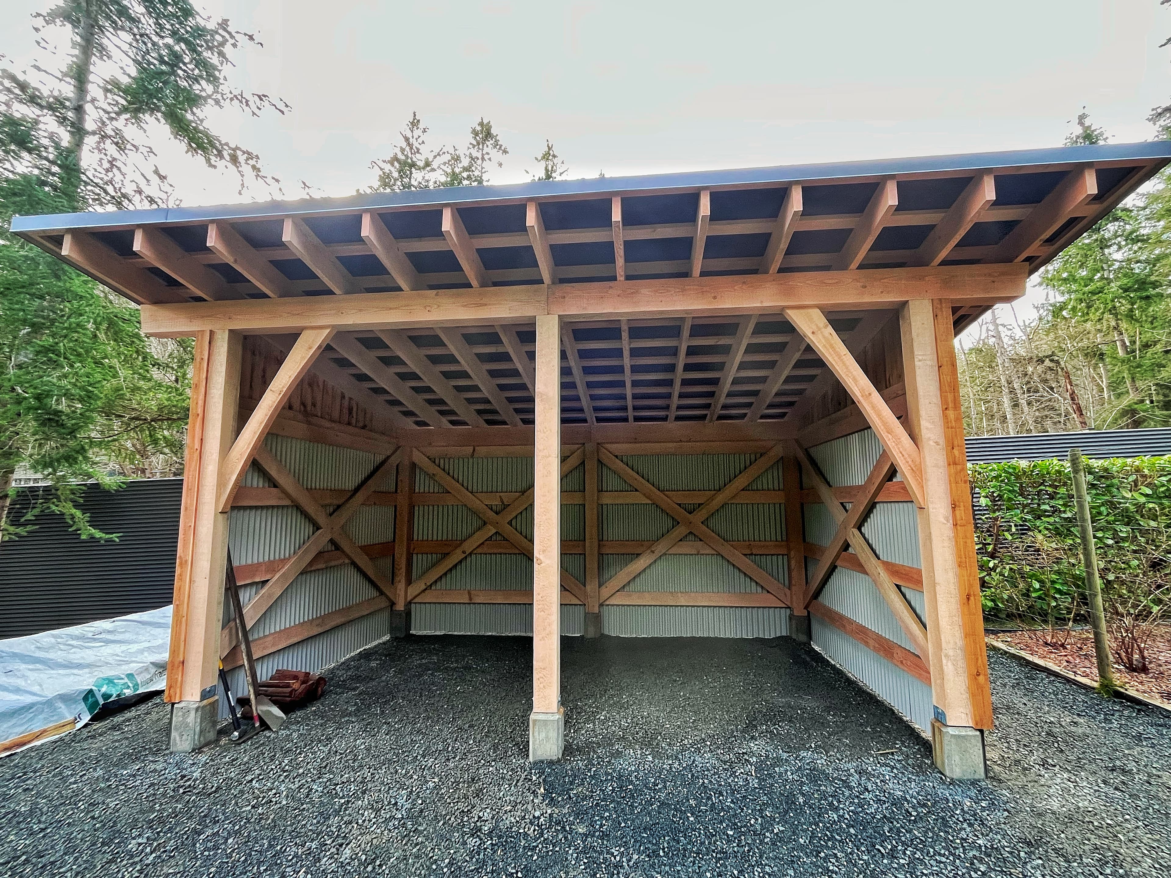 Open timber carport structure with exposed beams and braces